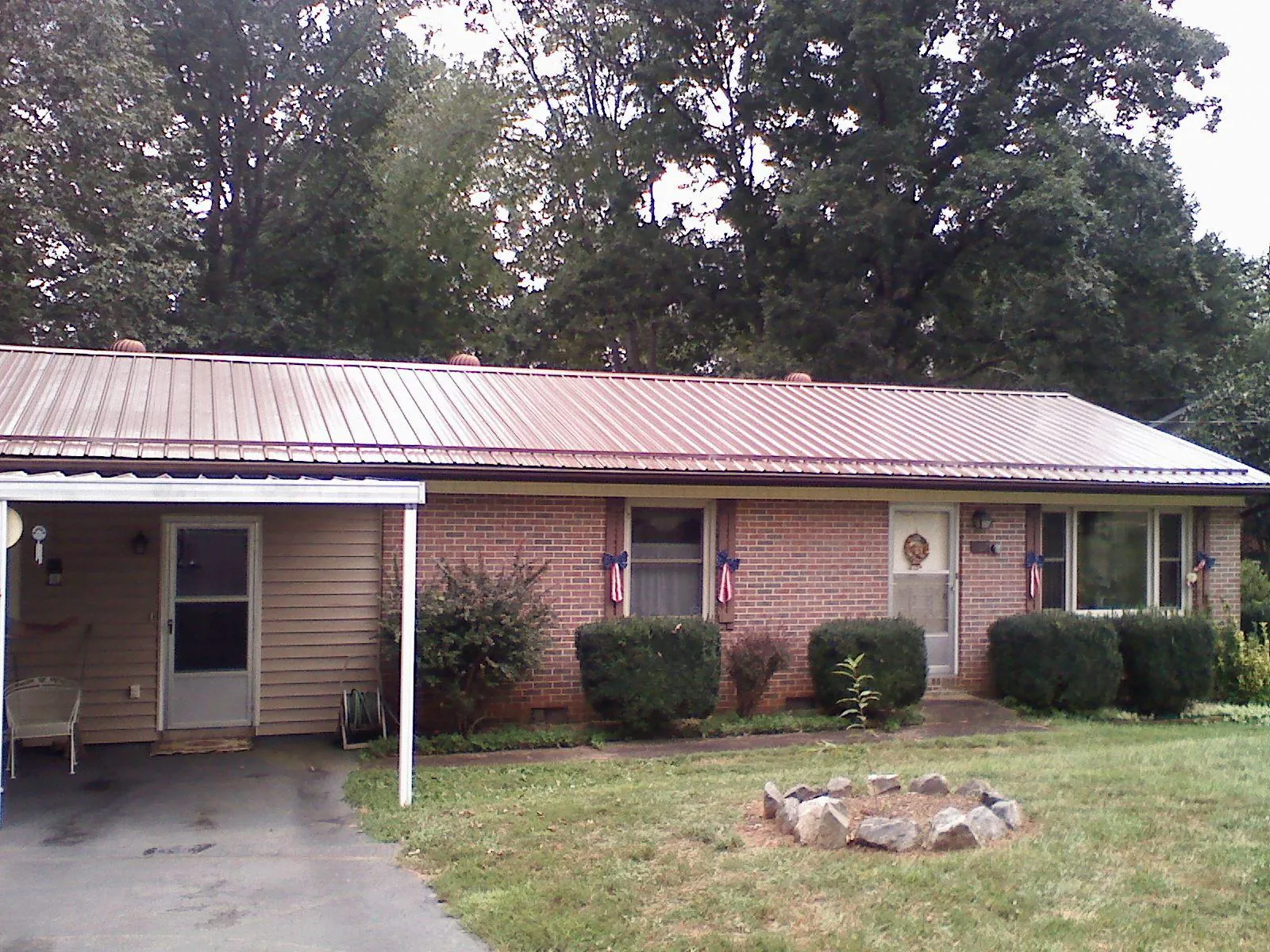 Bronze metal roof and carport on a brick ranch home — Roof Repair work by our crew in Reisterstown