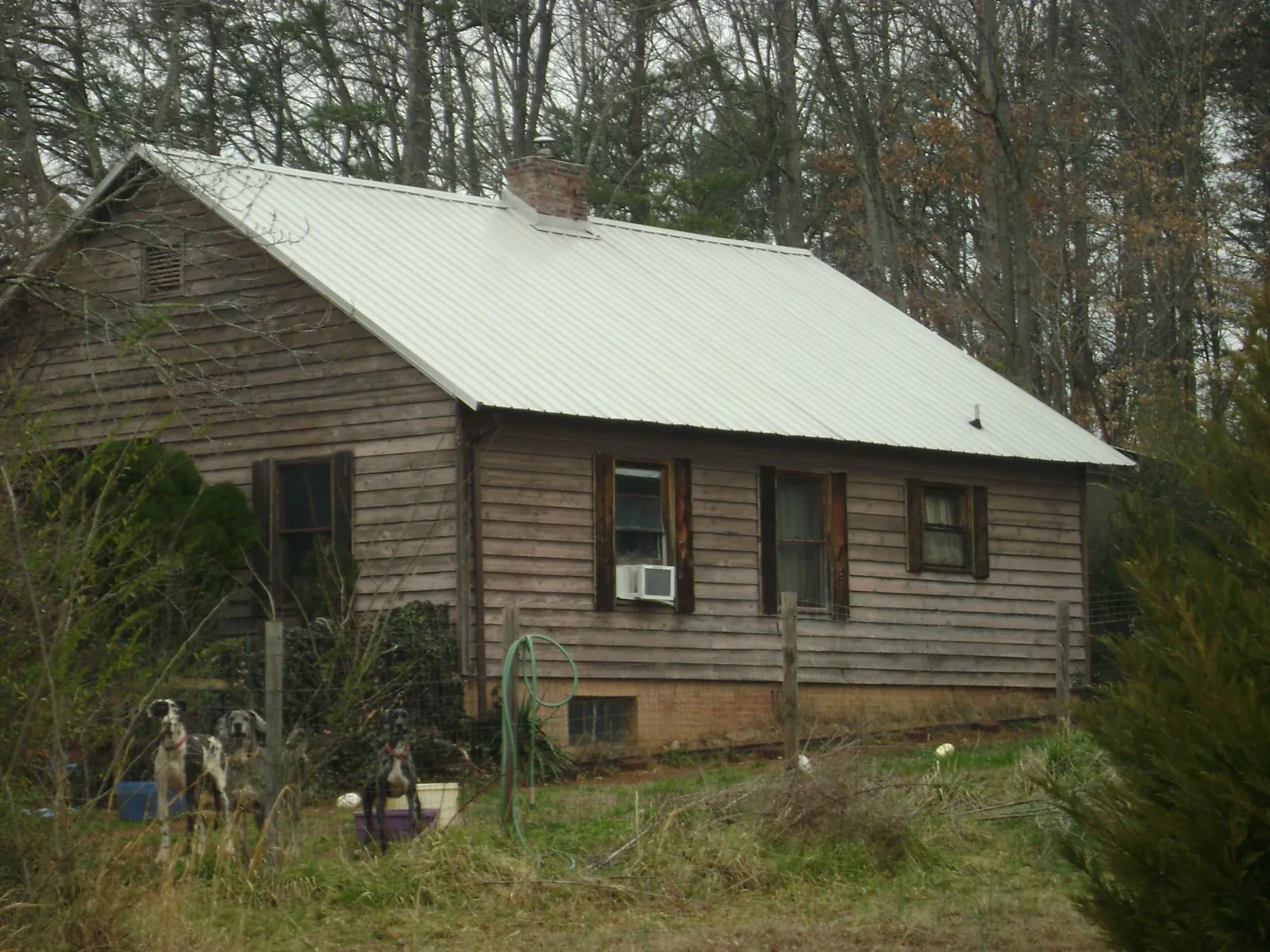 White metal roof on an old wood sided farmhouse, from a Metal Roof Installation job in Reisterstown
